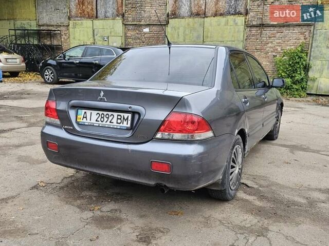 Сірий Міцубісі Lancer, об'ємом двигуна 1.58 л та пробігом 200 тис. км за 1700 $, фото 3 на Automoto.ua