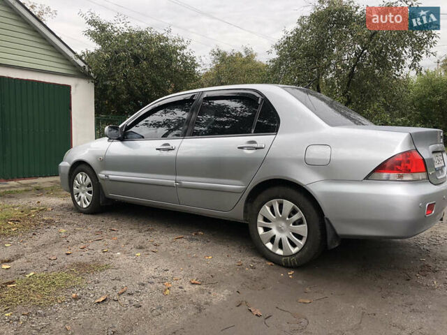 Сірий Міцубісі Lancer, об'ємом двигуна 1.58 л та пробігом 240 тис. км за 4299 $, фото 8 на Automoto.ua