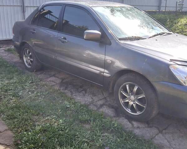 Серый Мицубиси Лансер, объемом двигателя 1.6 л и пробегом 153 тыс. км за 5600 $, фото 7 на Automoto.ua