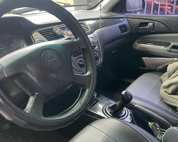 Синий Мицубиси Лансер, объемом двигателя 1.58 л и пробегом 234 тыс. км за 3500 $, фото 12 на Automoto.ua