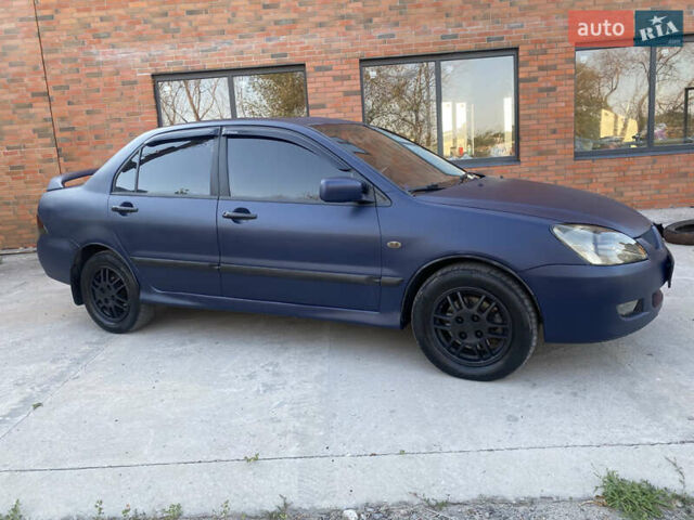 Синий Мицубиси Лансер, объемом двигателя 2 л и пробегом 100 тыс. км за 4999 $, фото 3 на Automoto.ua