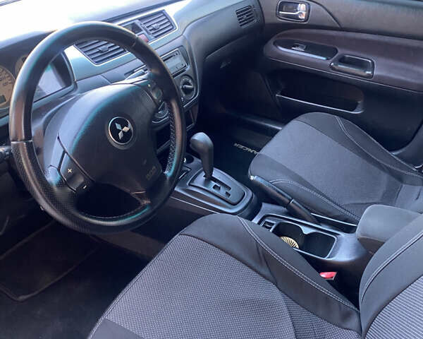 Синий Мицубиси Лансер, объемом двигателя 2 л и пробегом 100 тыс. км за 4999 $, фото 11 на Automoto.ua