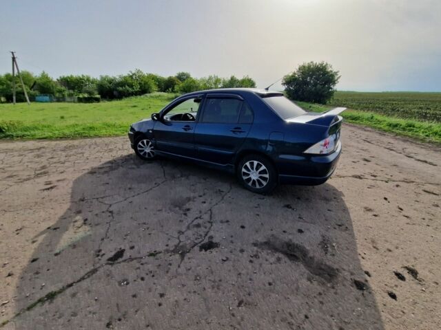 Синий Мицубиси Лансер, объемом двигателя 2 л и пробегом 260 тыс. км за 4200 $, фото 2 на Automoto.ua