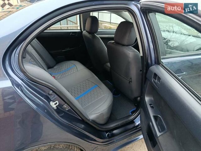 Синий Мицубиси Лансер, объемом двигателя 1.5 л и пробегом 211 тыс. км за 5222 $, фото 24 на Automoto.ua