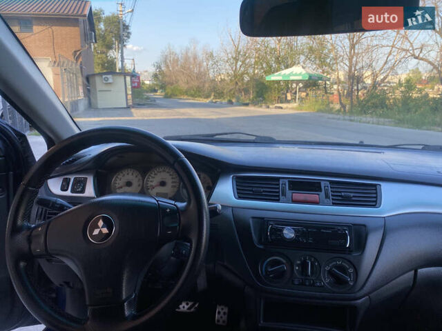 Синий Мицубиси Лансер, объемом двигателя 2 л и пробегом 100 тыс. км за 4999 $, фото 10 на Automoto.ua