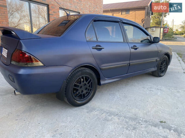 Синий Мицубиси Лансер, объемом двигателя 2 л и пробегом 100 тыс. км за 4999 $, фото 5 на Automoto.ua