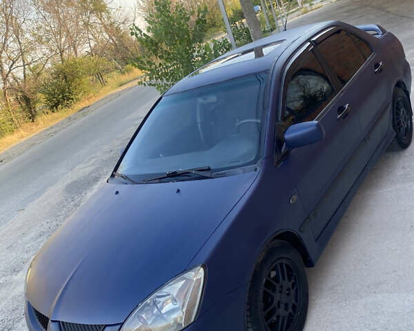 Синий Мицубиси Лансер, объемом двигателя 2 л и пробегом 100 тыс. км за 4999 $, фото 4 на Automoto.ua