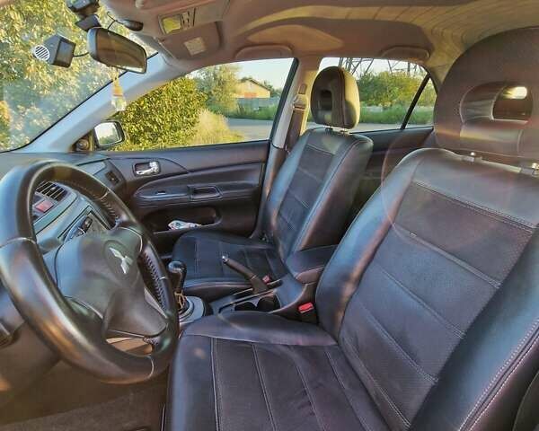 Синий Мицубиси Лансер, объемом двигателя 1.6 л и пробегом 197 тыс. км за 6500 $, фото 11 на Automoto.ua