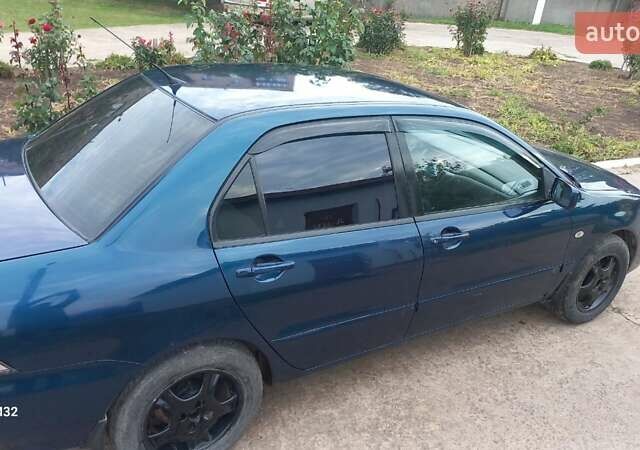 Синій Міцубісі Lancer, об'ємом двигуна 1.58 л та пробігом 220 тис. км за 4200 $, фото 3 на Automoto.ua
