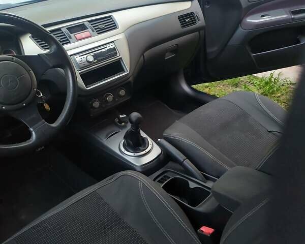 Синій Міцубісі Lancer, об'ємом двигуна 2 л та пробігом 201 тис. км за 4800 $, фото 10 на Automoto.ua