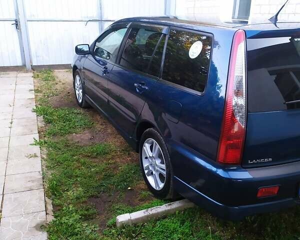 Синій Міцубісі Lancer, об'ємом двигуна 2 л та пробігом 201 тис. км за 4800 $, фото 22 на Automoto.ua