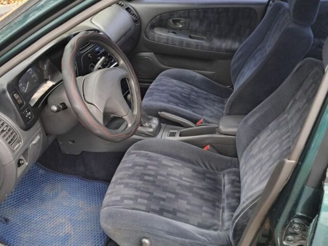 Зеленый Мицубиси Лансер, объемом двигателя 1.3 л и пробегом 400 тыс. км за 2300 $, фото 5 на Automoto.ua