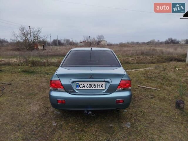 Зеленый Мицубиси Лансер, объемом двигателя 1.58 л и пробегом 224 тыс. км за 3500 $, фото 1 на Automoto.ua