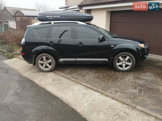 Черный Мицубиси Аутлендер ХЛ, объемом двигателя 2.36 л и пробегом 41 тыс. км за 12000 $, фото 1 на Automoto.ua