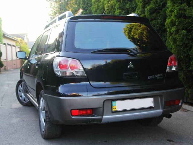 Чорний Міцубісі Аутлендер, об'ємом двигуна 2 л та пробігом 251 тис. км за 4990 $, фото 1 на Automoto.ua