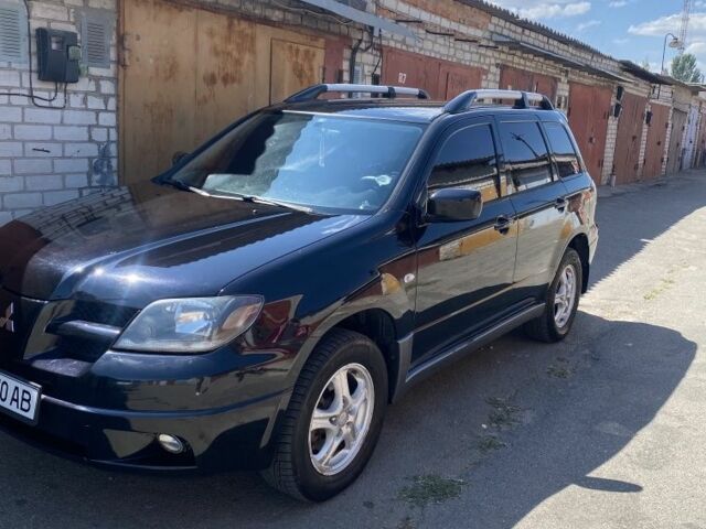 Черный Мицубиси Аутлендер, объемом двигателя 2.4 л и пробегом 312 тыс. км за 6500 $, фото 1 на Automoto.ua
