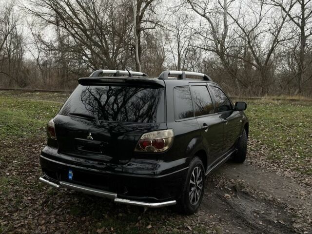 Черный Мицубиси Аутлендер, объемом двигателя 2.4 л и пробегом 200 тыс. км за 5800 $, фото 3 на Automoto.ua