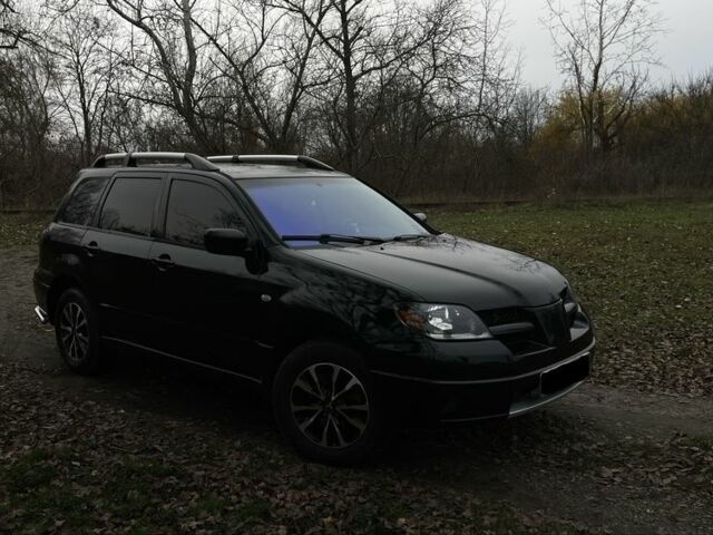 Черный Мицубиси Аутлендер, объемом двигателя 2.4 л и пробегом 200 тыс. км за 5800 $, фото 2 на Automoto.ua