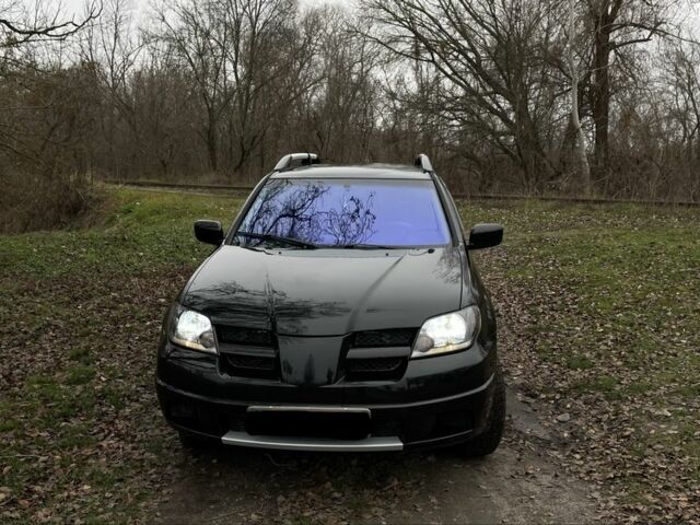 Черный Мицубиси Аутлендер, объемом двигателя 2.4 л и пробегом 200 тыс. км за 5800 $, фото 1 на Automoto.ua