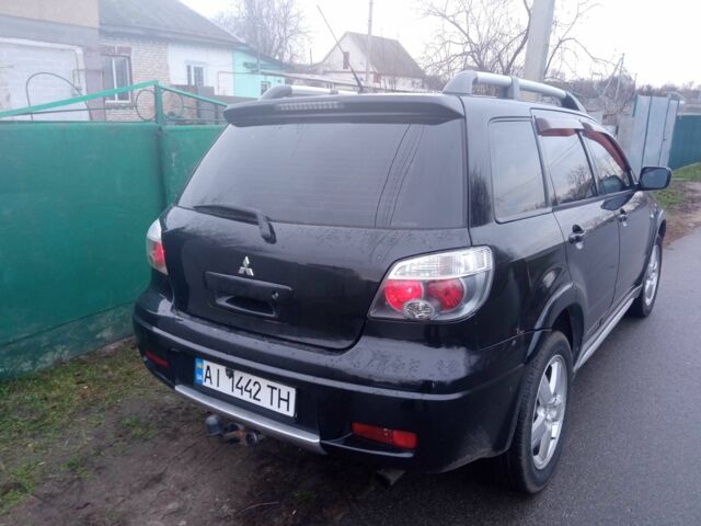 Чорний Міцубісі Аутлендер, об'ємом двигуна 2 л та пробігом 220 тис. км за 5599 $, фото 1 на Automoto.ua