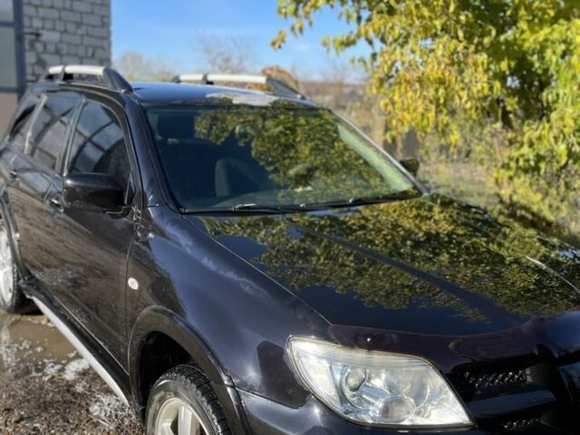 Черный Мицубиси Аутлендер, объемом двигателя 2 л и пробегом 156 тыс. км за 4200 $, фото 1 на Automoto.ua