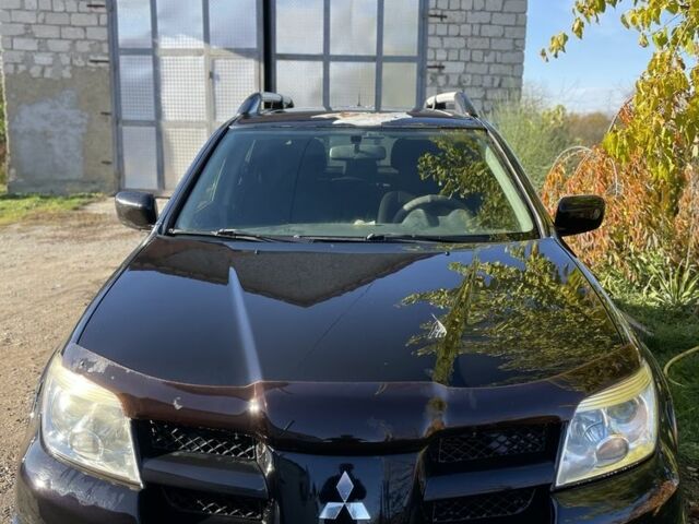 Черный Мицубиси Аутлендер, объемом двигателя 2 л и пробегом 156 тыс. км за 4200 $, фото 2 на Automoto.ua