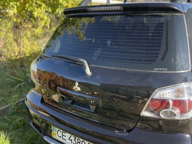 Черный Мицубиси Аутлендер, объемом двигателя 2 л и пробегом 156 тыс. км за 4200 $, фото 5 на Automoto.ua