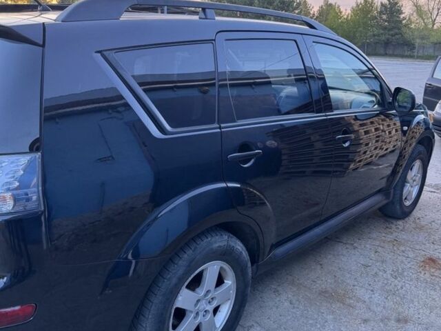 Черный Мицубиси Аутлендер, объемом двигателя 2.4 л и пробегом 220 тыс. км за 9500 $, фото 1 на Automoto.ua