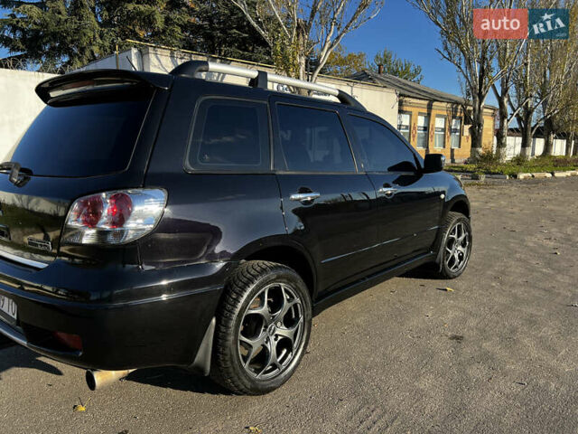 Черный Мицубиси Аутлендер, объемом двигателя 2.4 л и пробегом 267 тыс. км за 6900 $, фото 5 на Automoto.ua