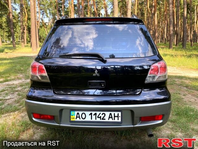 Черный Мицубиси Аутлендер, объемом двигателя 2 л и пробегом 195 тыс. км за 5650 $, фото 12 на Automoto.ua