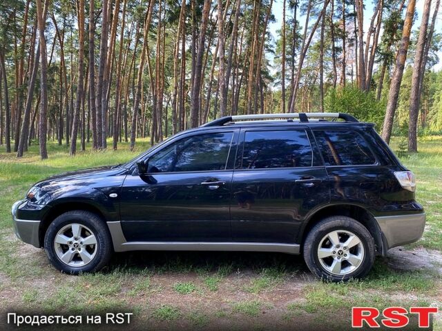 Черный Мицубиси Аутлендер, объемом двигателя 2 л и пробегом 195 тыс. км за 5650 $, фото 1 на Automoto.ua