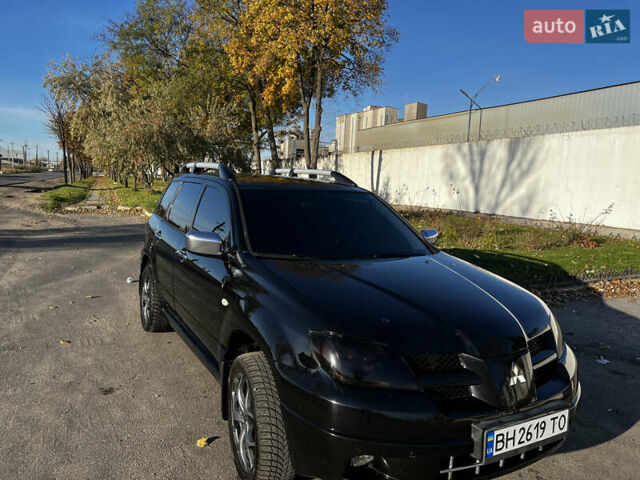 Черный Мицубиси Аутлендер, объемом двигателя 2.4 л и пробегом 267 тыс. км за 6900 $, фото 2 на Automoto.ua
