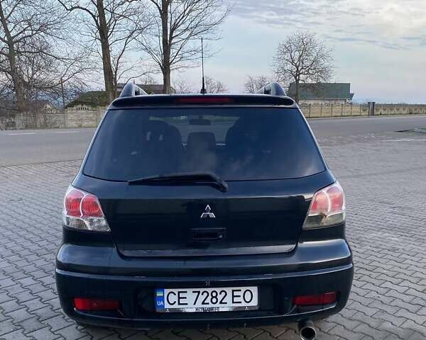 Чорний Міцубісі Аутлендер, об'ємом двигуна 2.38 л та пробігом 294 тис. км за 4550 $, фото 8 на Automoto.ua