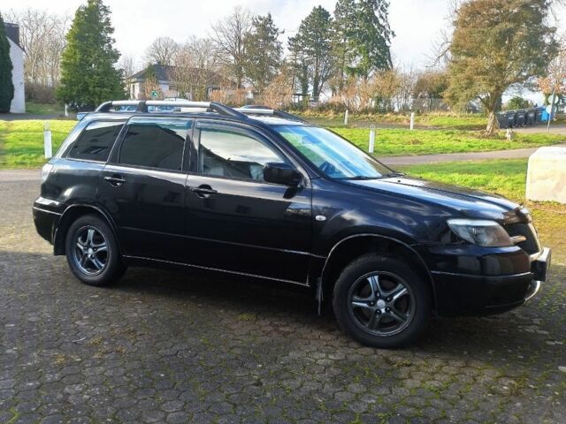 Черный Мицубиси Аутлендер, объемом двигателя 2.4 л и пробегом 269 тыс. км за 5252 $, фото 1 на Automoto.ua