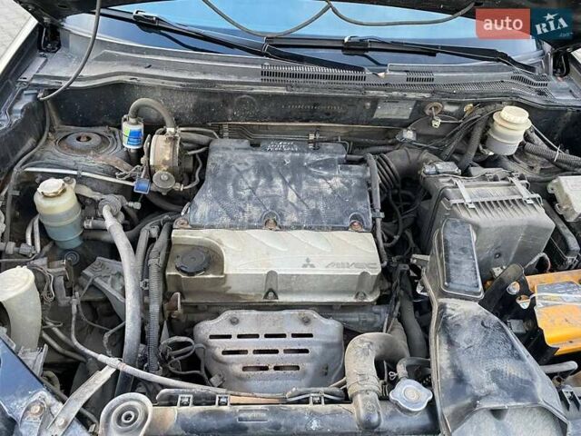 Чорний Міцубісі Аутлендер, об'ємом двигуна 2.38 л та пробігом 294 тис. км за 4550 $, фото 11 на Automoto.ua