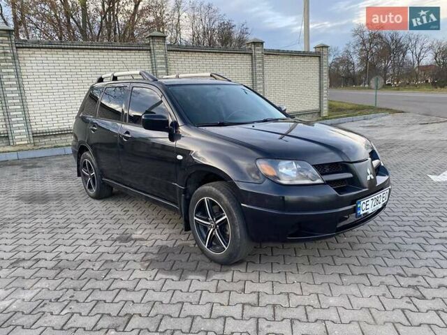 Чорний Міцубісі Аутлендер, об'ємом двигуна 2.38 л та пробігом 294 тис. км за 4550 $, фото 12 на Automoto.ua