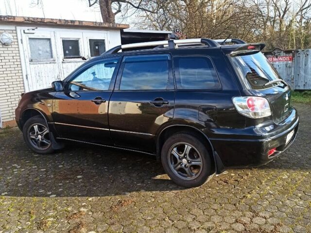 Черный Мицубиси Аутлендер, объемом двигателя 2.4 л и пробегом 269 тыс. км за 5252 $, фото 2 на Automoto.ua