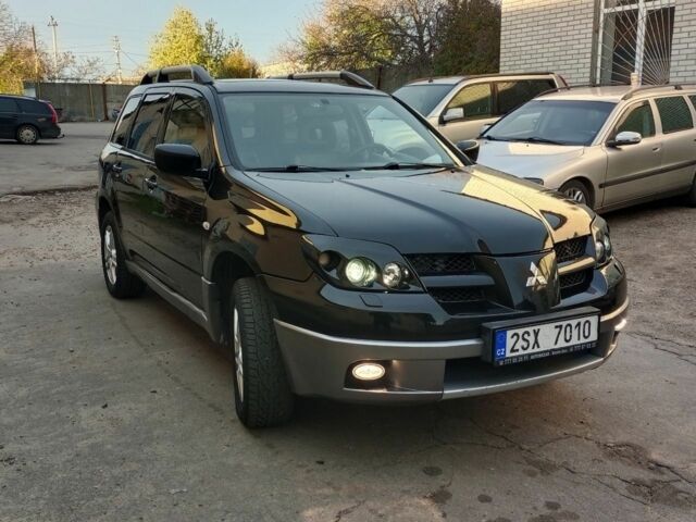 Черный Мицубиси Аутлендер, объемом двигателя 2.4 л и пробегом 243 тыс. км за 1846 $, фото 1 на Automoto.ua