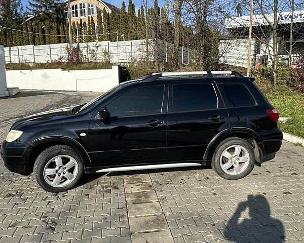 Черный Мицубиси Аутлендер, объемом двигателя 2.4 л и пробегом 307 тыс. км за 5600 $, фото 3 на Automoto.ua