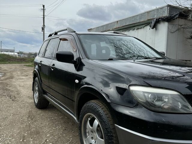 Черный Мицубиси Аутлендер, объемом двигателя 2.4 л и пробегом 258 тыс. км за 5400 $, фото 1 на Automoto.ua