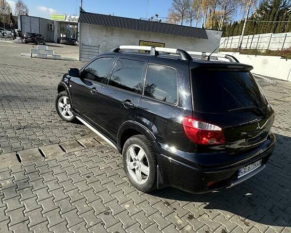 Черный Мицубиси Аутлендер, объемом двигателя 2.4 л и пробегом 307 тыс. км за 5600 $, фото 6 на Automoto.ua