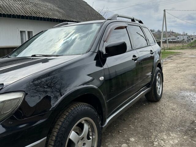 Черный Мицубиси Аутлендер, объемом двигателя 2.4 л и пробегом 258 тыс. км за 5400 $, фото 2 на Automoto.ua