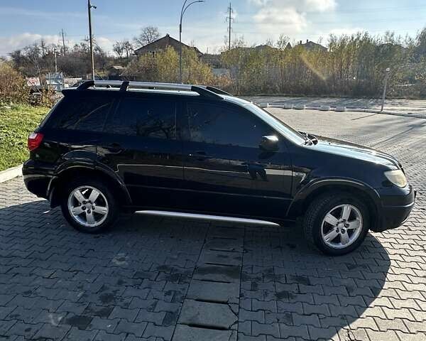 Черный Мицубиси Аутлендер, объемом двигателя 2.4 л и пробегом 307 тыс. км за 5600 $, фото 4 на Automoto.ua