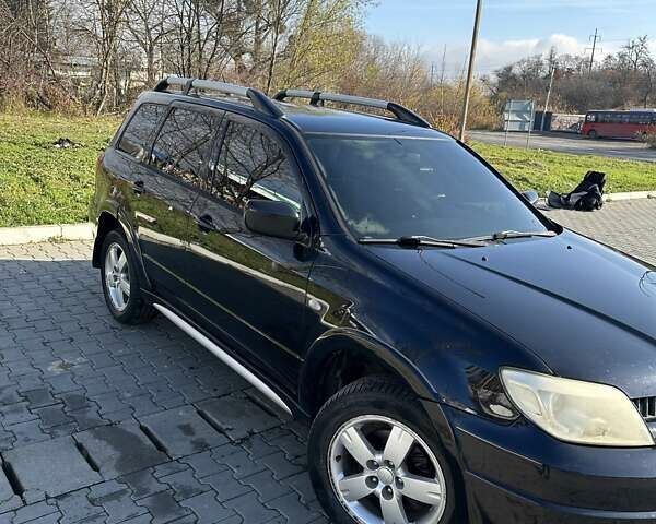 Черный Мицубиси Аутлендер, объемом двигателя 2.4 л и пробегом 307 тыс. км за 5600 $, фото 2 на Automoto.ua