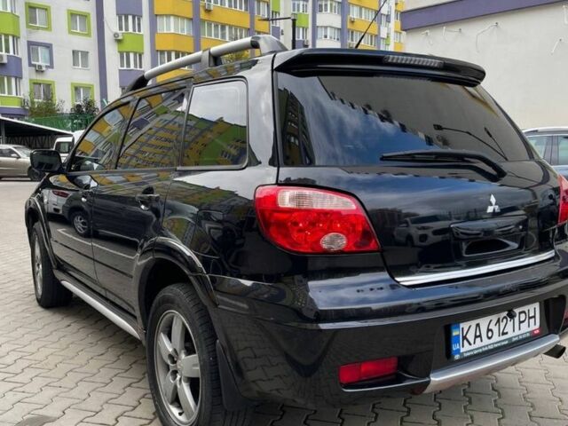 Черный Мицубиси Аутлендер, объемом двигателя 2.38 л и пробегом 270 тыс. км за 5900 $, фото 1 на Automoto.ua