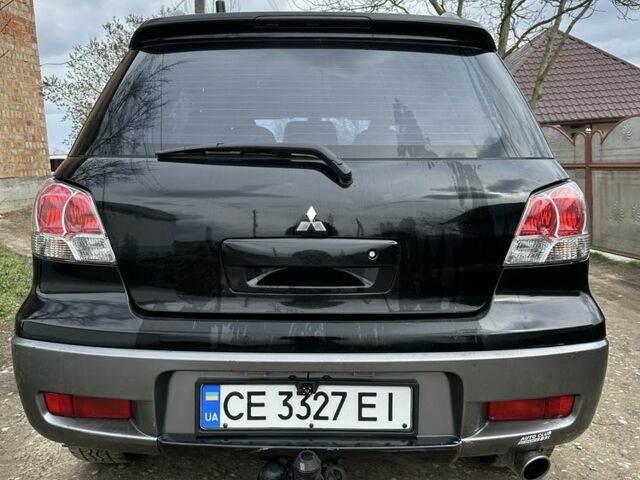 Черный Мицубиси Аутлендер, объемом двигателя 2.4 л и пробегом 258 тыс. км за 5400 $, фото 3 на Automoto.ua