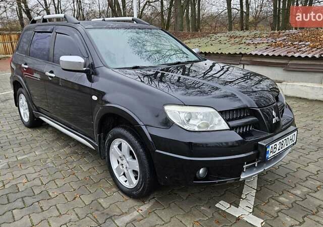 Черный Мицубиси Аутлендер, объемом двигателя 2.4 л и пробегом 167 тыс. км за 6150 $, фото 1 на Automoto.ua
