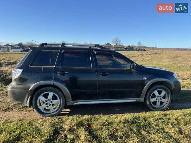 Черный Мицубиси Аутлендер, объемом двигателя 2.38 л и пробегом 230 тыс. км за 5350 $, фото 2 на Automoto.ua