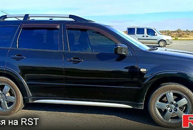 Черный Мицубиси Аутлендер, объемом двигателя 2.4 л и пробегом 265 тыс. км за 7500 $, фото 2 на Automoto.ua