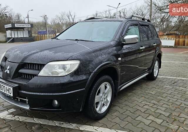 Черный Мицубиси Аутлендер, объемом двигателя 2.4 л и пробегом 167 тыс. км за 6150 $, фото 2 на Automoto.ua